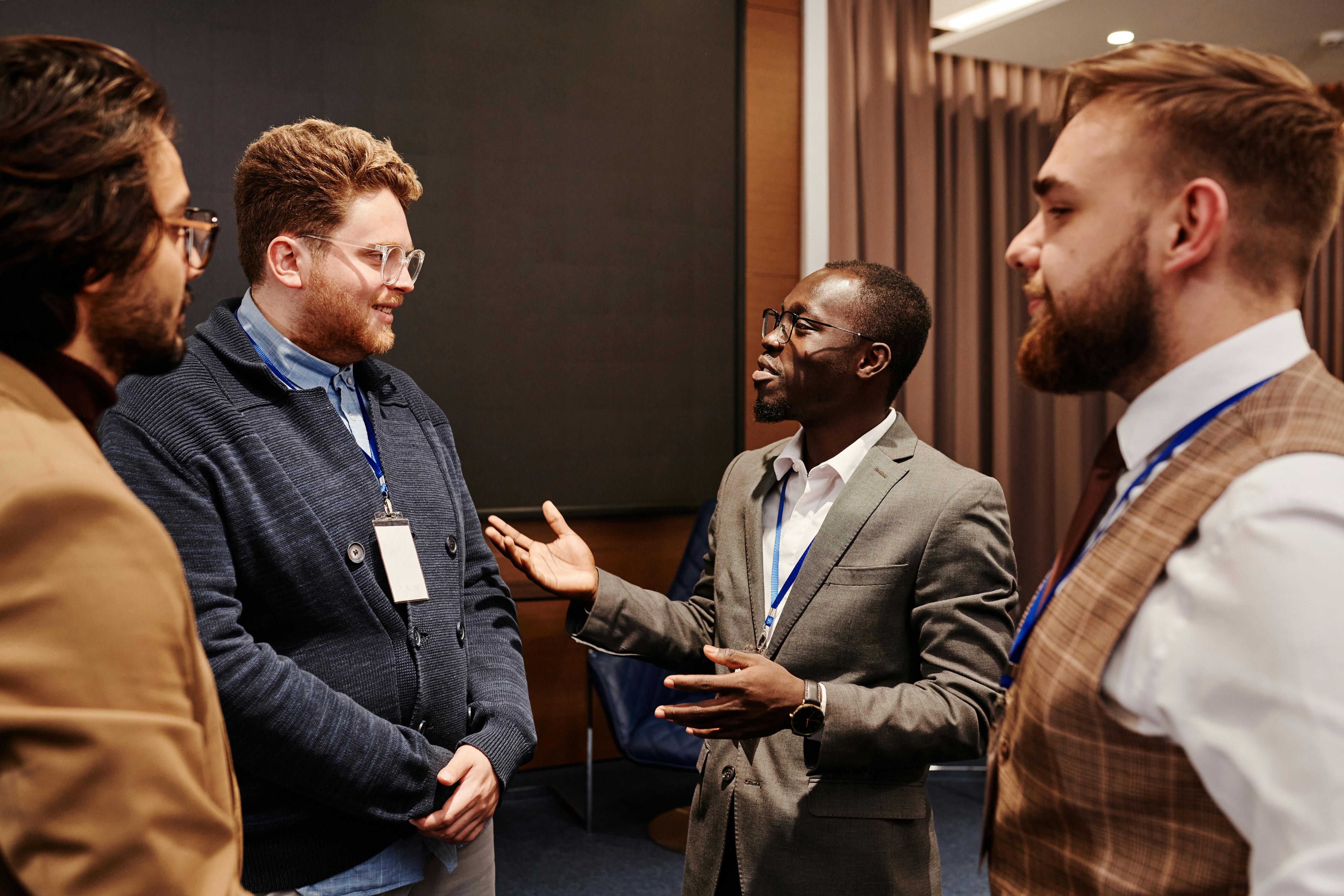 photo of men having a conversation in a business conference setting