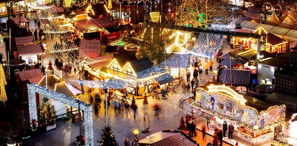 photo from above of a Berlin Christmas market with lights and stalls.